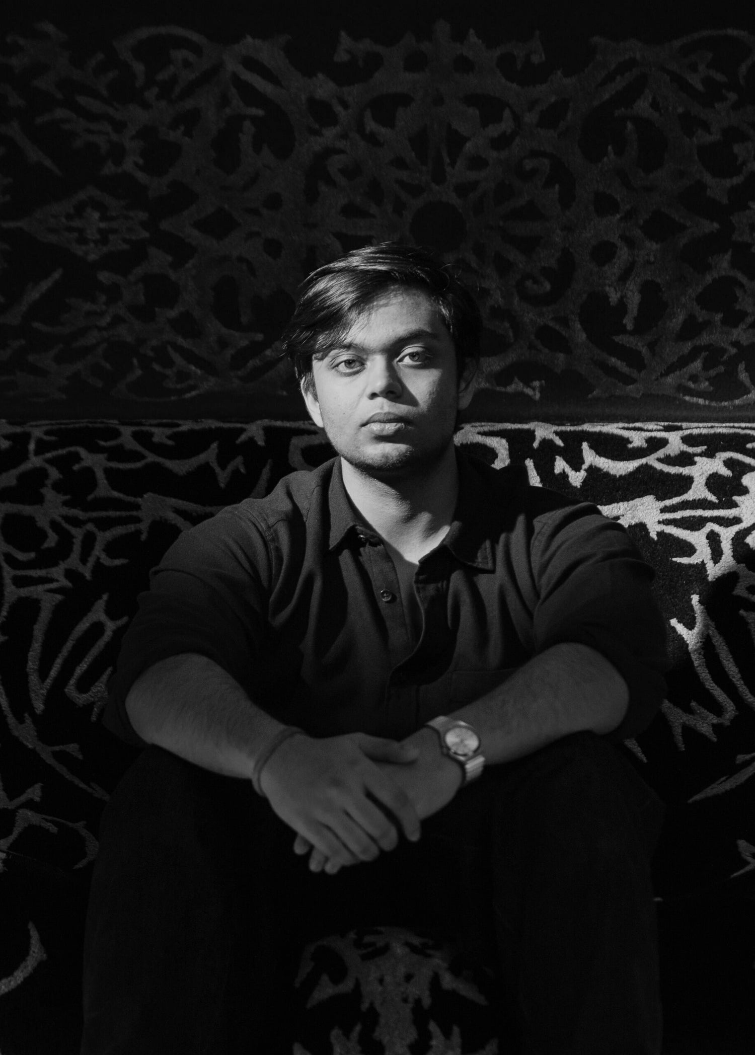 Cultureweave's founder, Ashvin Gupta  Siiting on the rugs her designed